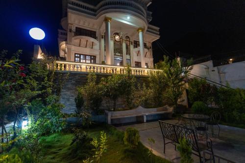 a building with a clock on it at night at The White House Villa 8 bedroom with Swimming Pool in Kathmandu