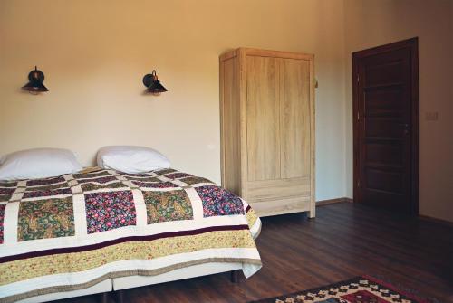 a bedroom with a bed and a wooden floor at Ostoja Wigierski in Mikolajewo