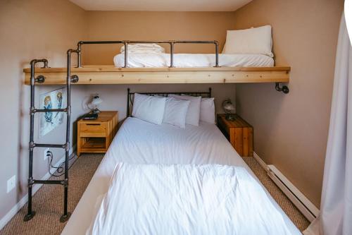 a bedroom with two bunk beds in a room at Peaks of Radium by StayIn in Radium Hot Springs
