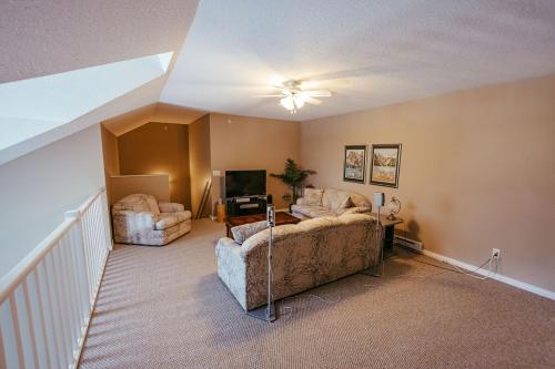 a living room with a couch and a chair at Peaks of Radium by StayIn in Radium Hot Springs