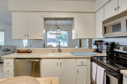 a kitchen with white cabinets and a sink at Centrally Located St Simons Island Getaway! in Ebo Landing