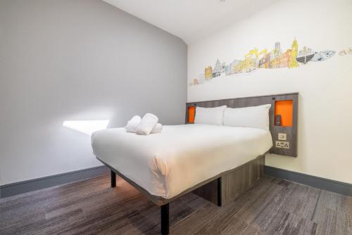 a bedroom with a large bed in a room at easyHotel Belfast in Belfast