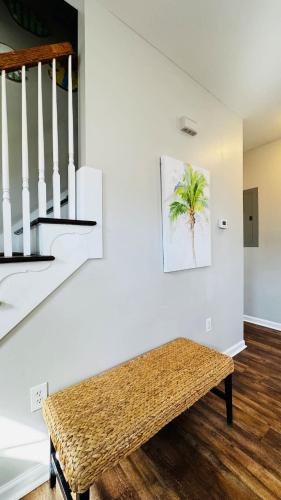 a room with a bench next to a staircase at Beautiful duplex in Murrells Inlet B in Myrtle Beach