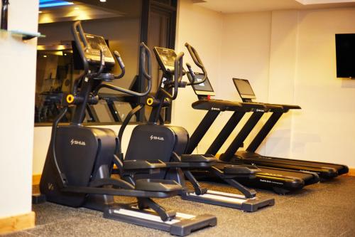 a row of exercise bikes in a gym at Tha Nickolee Hotel in Nanyuki