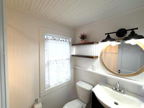 a bathroom with a toilet and a sink and a mirror at Cottage 7 - Stand Alone 1 Bedroom / 1 Bath in Wolfeboro