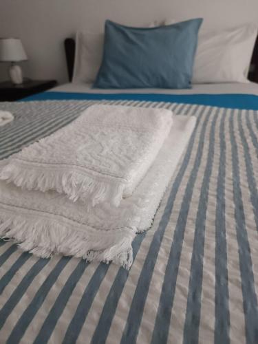 a white blanket sitting on top of a bed at Bal&Bal in Ferrel