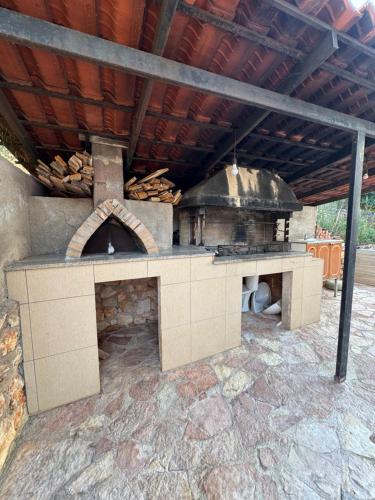 a large outdoor kitchen with a large oven at CAUSHI Apartments Ksamil in Ksamil