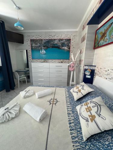 a bedroom with a large bed with pillows on it at Il Veliero Bianco in Cala Gonone