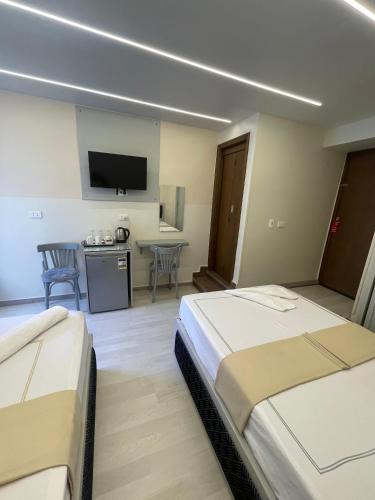 a hotel room with two beds and a kitchen at Ambiance Downtown Cairo Hotel in Cairo