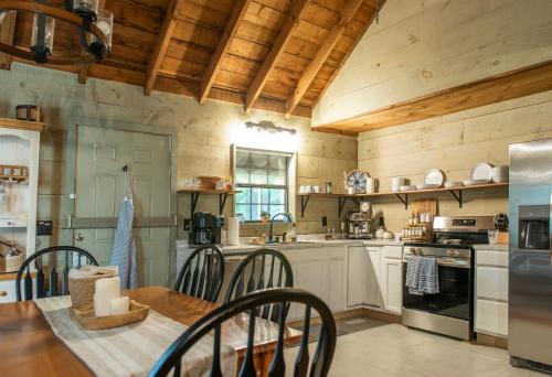 a kitchen with wooden ceilings and a table and chairs at Secluded Creekside Cabin Hot Tub and Fire Pit in Cosby