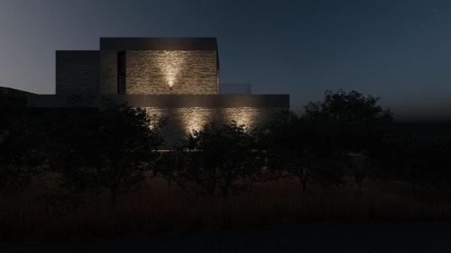 a building lit up at night with lights on it at Seanatra Luxury Villas in Ferma