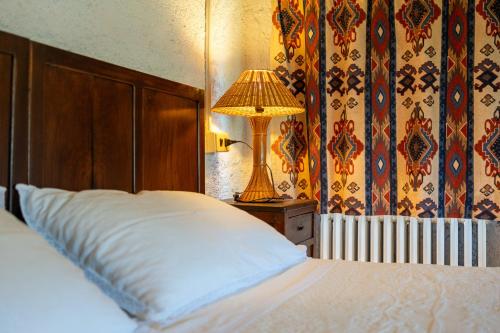 a bedroom with a bed and a lamp on a nightstand at Il Rancho Grande in Città di Castello