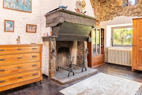 an old stone fireplace in a room with a dresser at Il Rancho Grande in Città di Castello