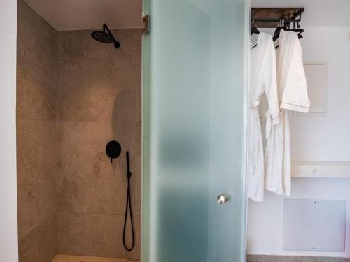 a bathroom with a shower with a glass door at Arkasa Palace in Arkasa