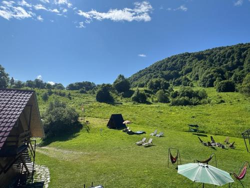 a group of people laying on the grass in a field at Mountain House Chirdili in Chirdili