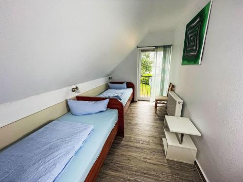 two beds in a room with a window at Holiday Home Müritz Ferienpark Röbel-62 by Interhome in Röbel