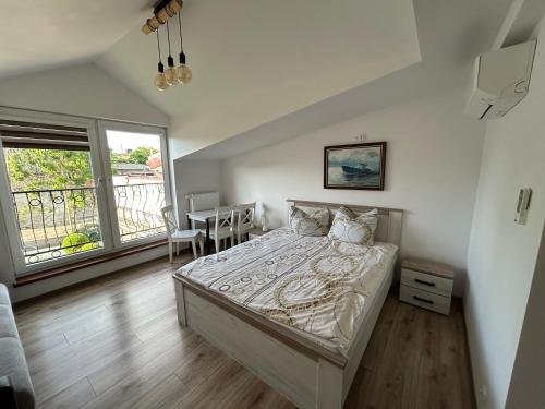 a bedroom with a bed and a dining table at Pokoje Gościnne Angelika in Swarzewo