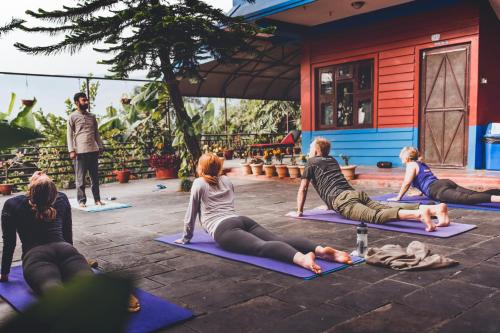 a group of people doing yoga in a courtyard at Sadhana Yoga Retreat in Pokhara
