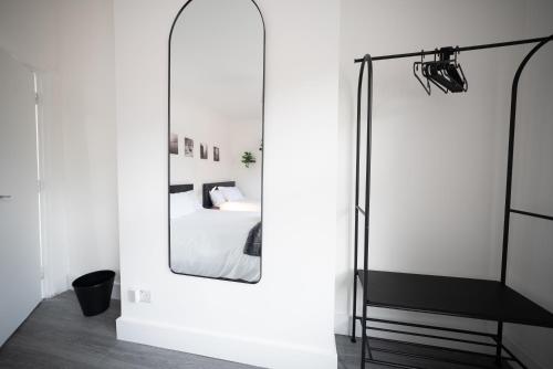 a bedroom with a mirror and a bed at 3BR Home Gem - sleeps 9 - Netflix - Near O2 & Greenwich Park in London
