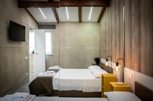 a bedroom with a bed and a tv in a room at Jubilee Mini Loft near Rome & Free Wi-Fi in Monterotondo