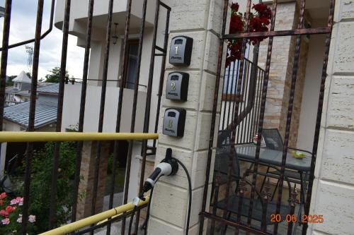 a iron fence with a chair on a balcony at Cozy House in Piatra Neamţ