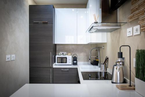 a small kitchen with a sink and a microwave at Jubilee Mini Loft near Rome & Free Wi-Fi in Monterotondo