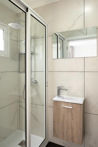 a bathroom with a sink and a shower at Franco's House II, Mar e Serra in Estreito da Calheta