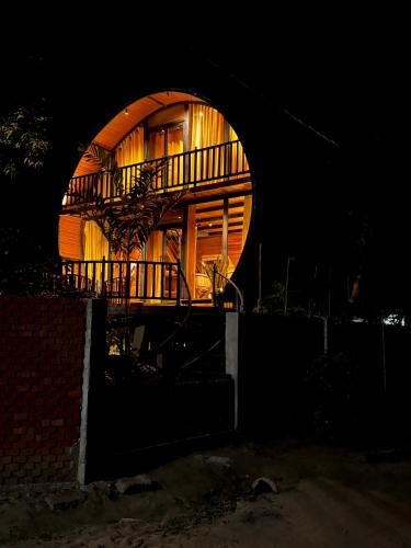 a round building with a round window at night at woodland sanctuary in Habarana