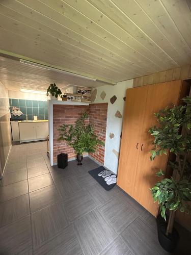 a room with a brick wall and a plant at AlongtheWay E77 in Ieriķi