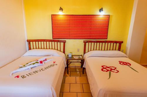 Ένα ή περισσότερα κρεβάτια σε δωμάτιο στο Hotel Casa Sun and Moon