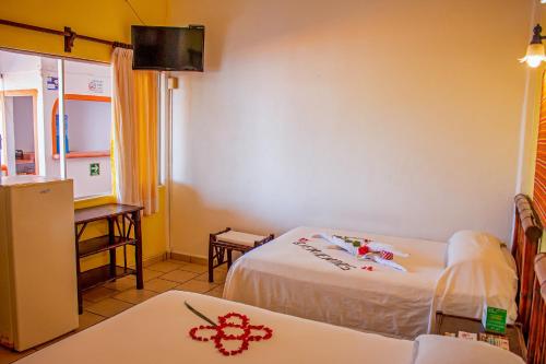 Ένα ή περισσότερα κρεβάτια σε δωμάτιο στο Hotel Casa Sun and Moon