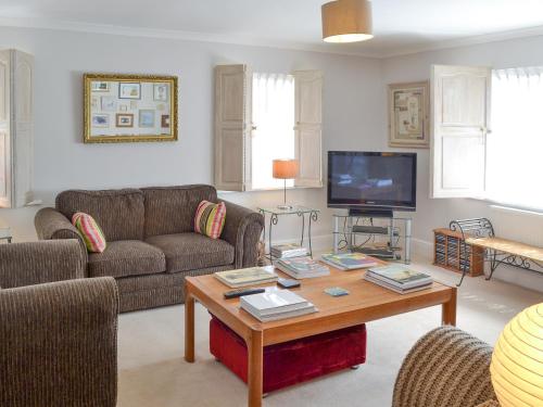 a living room with a couch and a coffee table at Trelawny Court in Saint Minver