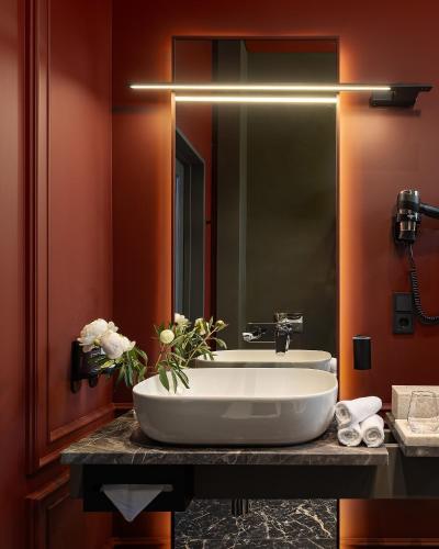 a bathroom with a white sink on a counter at LUBICH Concept Hotel in Lviv