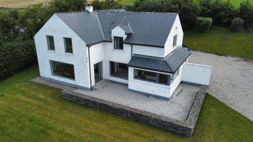 an aerial view of a white house with a roof at The Curlew in Carrigart