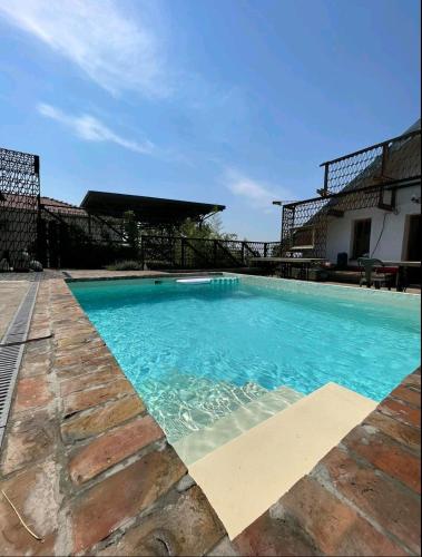 a swimming pool with blue water in front of a building at Train_house_ns in Petrovaradin