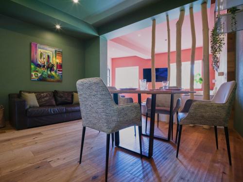 a dining room with a table and two chairs at COLORGRAM Loft - Colorful Design Apartment in Tyrol, presented by AlpenLuxus in Kramsach