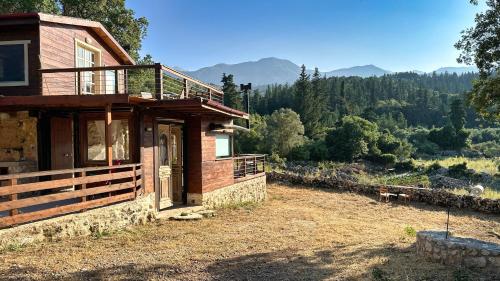 a wooden house with a view of the mountains at The Root House - Crete Stay in Vafés