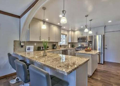 a large kitchen with a large island with chairs at 2148 Inverness Drive home in South Lake Tahoe