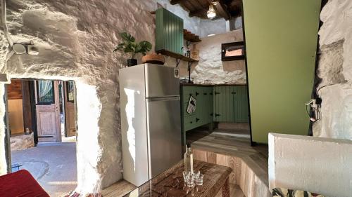 a kitchen with a white refrigerator in a room at The Root House - Crete Stay in Vafés