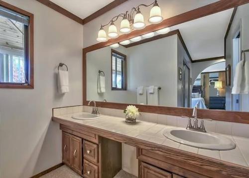 a bathroom with two sinks and a large mirror at 2148 Inverness Drive home in South Lake Tahoe
