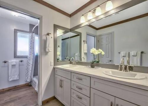 a bathroom with two sinks and a large mirror at 2148 Inverness Drive home in South Lake Tahoe