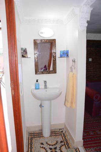 a bathroom with a sink and a mirror at Dar El Karam Fez in Fès