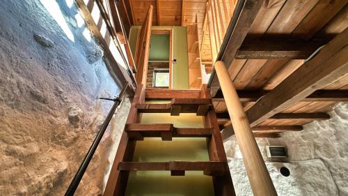 a wooden staircase in a building with a stair case at The Root House - Crete Stay in Vafés