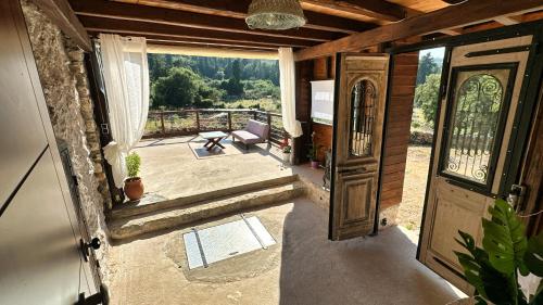 an open door of a house with a view of a patio at The Root House - Crete Stay in Vafés