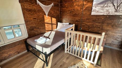 a bedroom with a crib in a log cabin at The Root House - Crete Stay in Vafés
