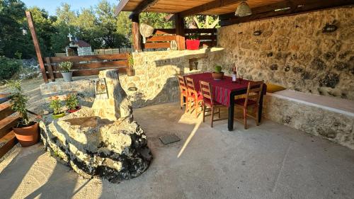 a patio with a table and chairs in a building at The Root House - Crete Stay in Vafés