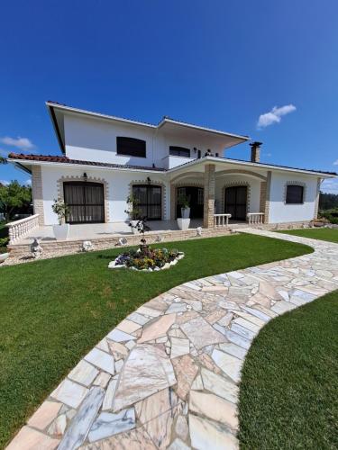 a house with a stone walkway in front of it at Casa do Vale in Leiria