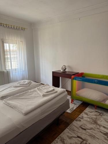 a bedroom with a bed and a desk and a table at Udobna kuca Sarajevo Baščaršija in Sarajevo
