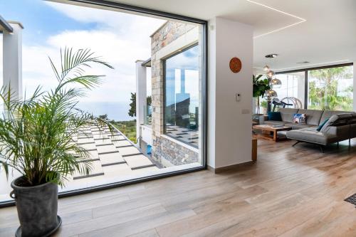 an open living room with a large glass door at BlueSkyline Owner's Listing, By Hellocrete in Chania Town