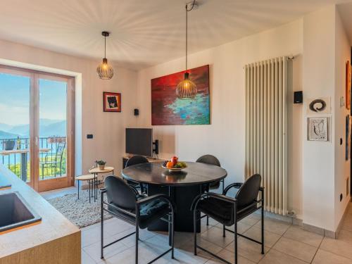 a living room with a table and chairs and a television at Apartment Buongusto by Interhome in Bugiallo